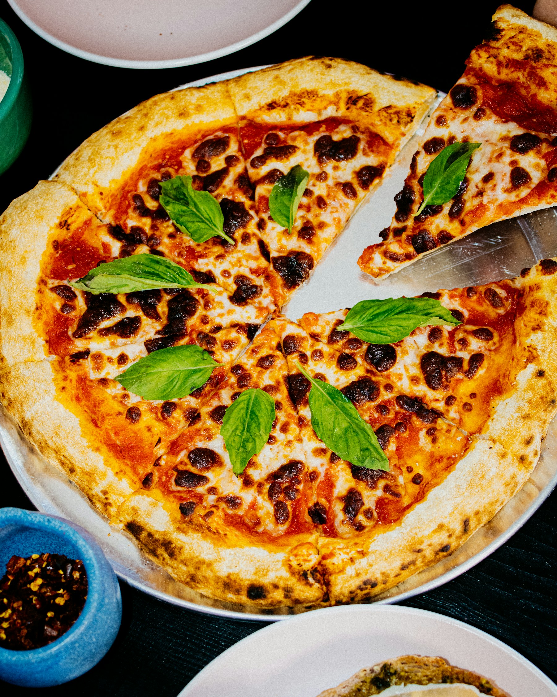 Cheese and basil pizza used as illustrative photography for a pizzeria study